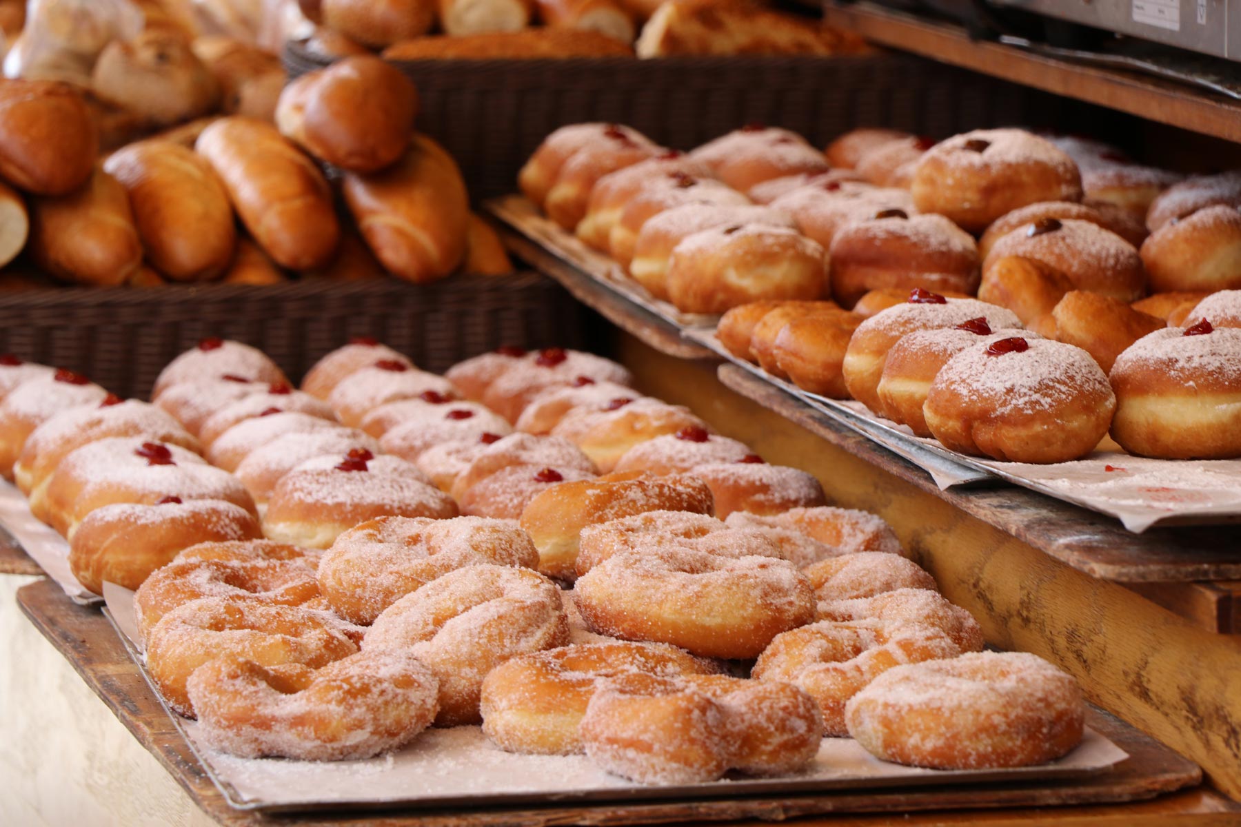 many donuts on baking sheets