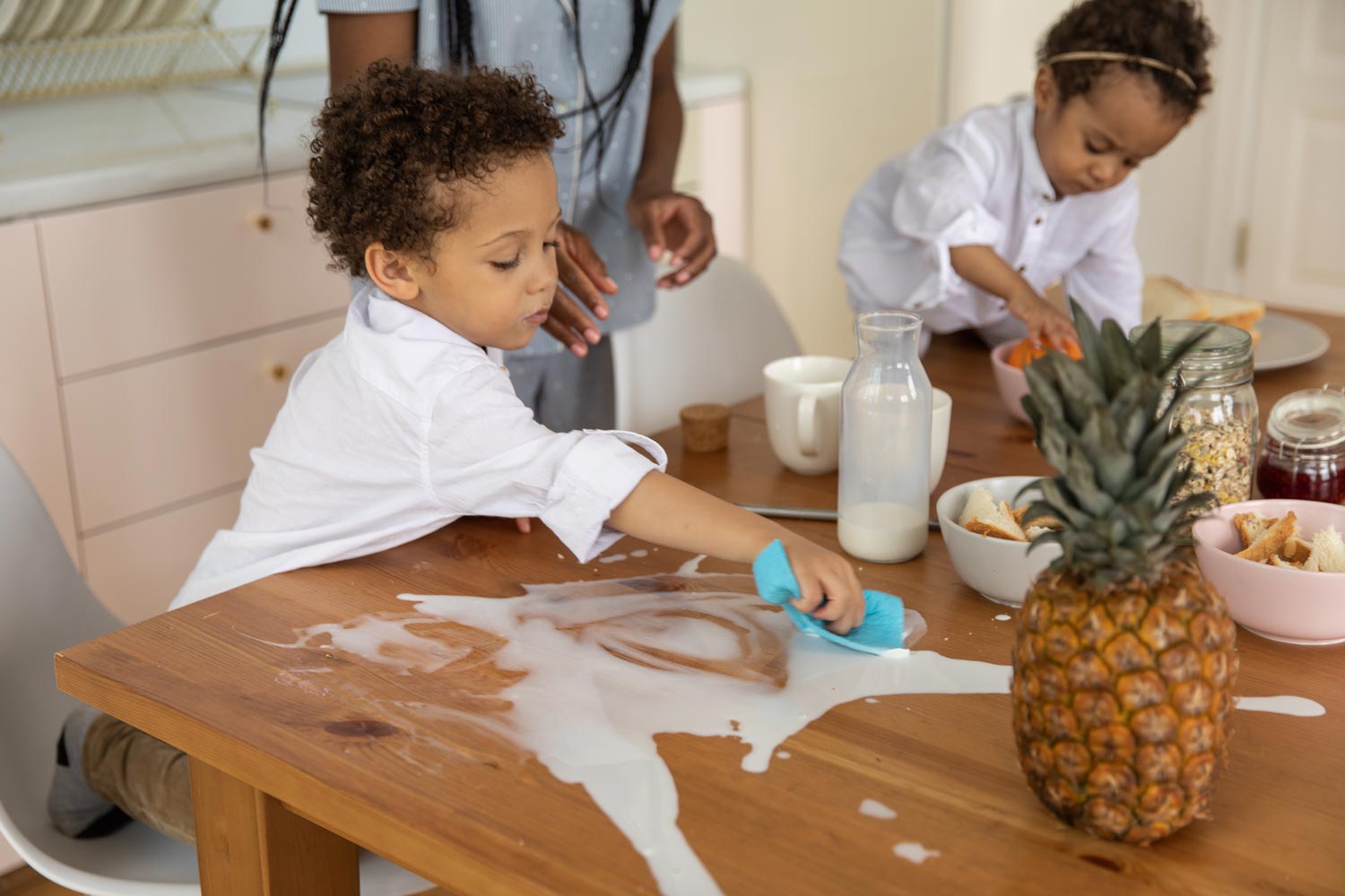 child cleaning up spilled milk