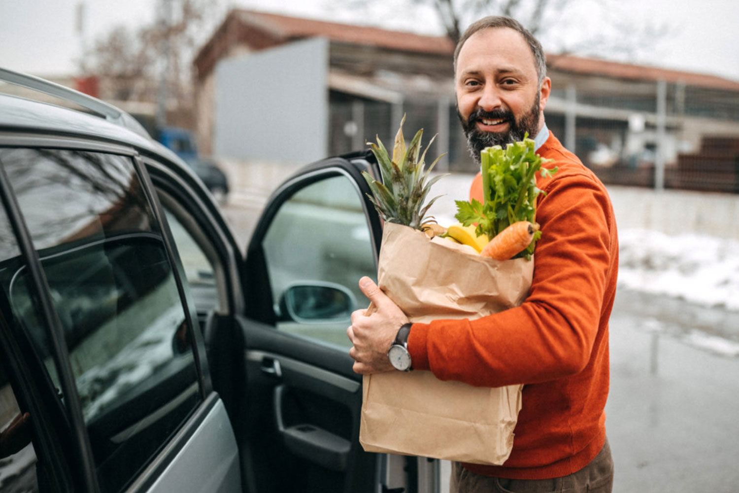 man holding a bag of vegtables and fruit