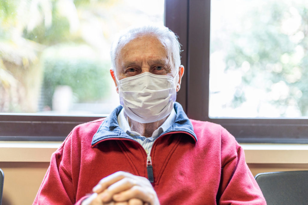 elderly man sitting in doctor's office