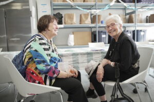 Two people sitting together at a table, smiling. 