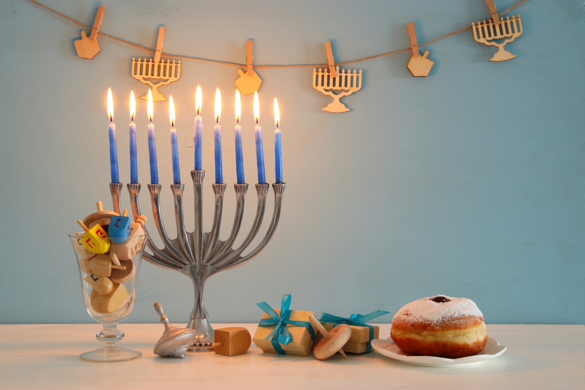 image of jewish holiday Hanukkah background with traditional spinnig top, menorah (traditional candelabra) and burning candles