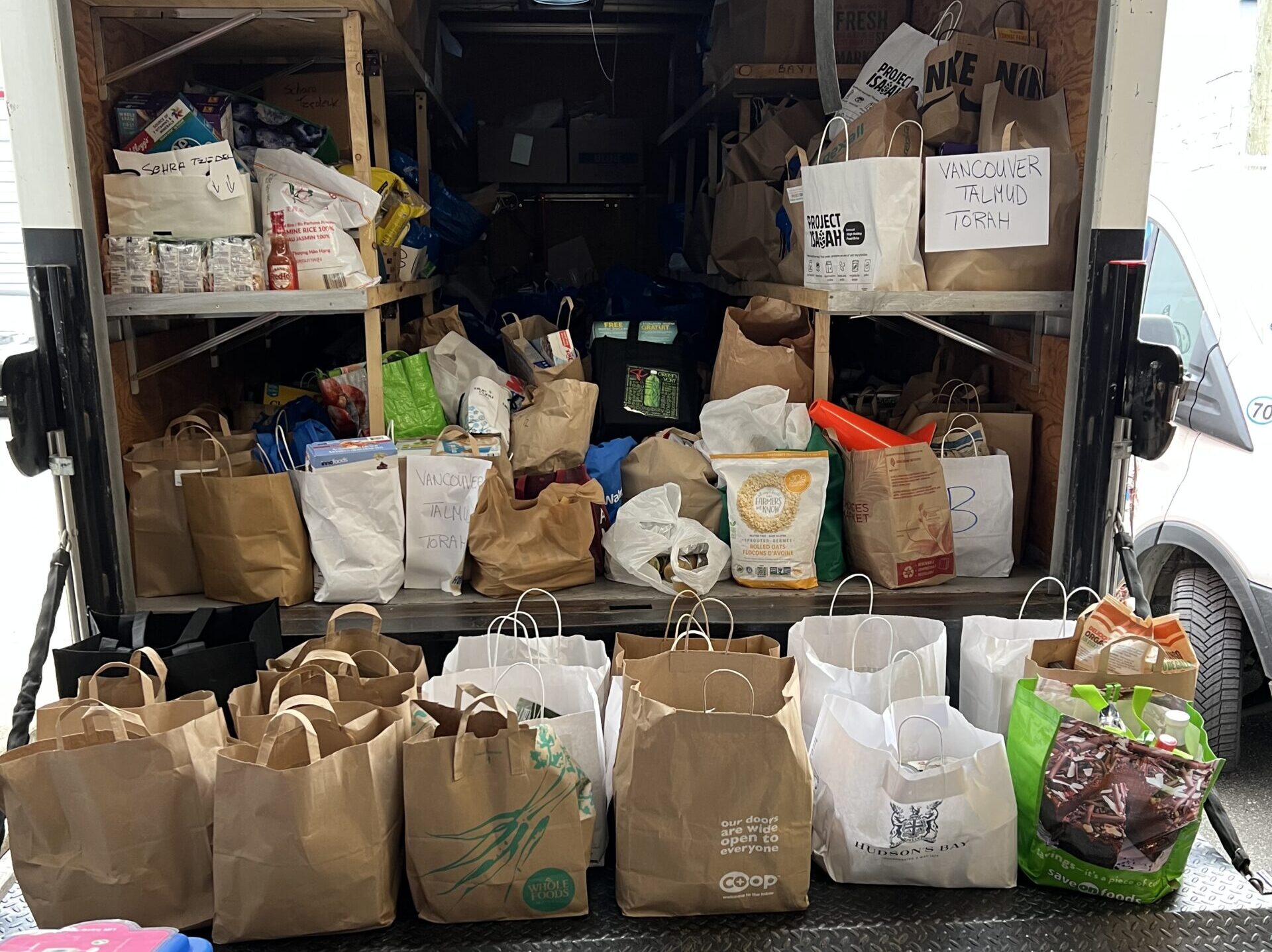 The JFS Delivery truck filled with donated bags of food.