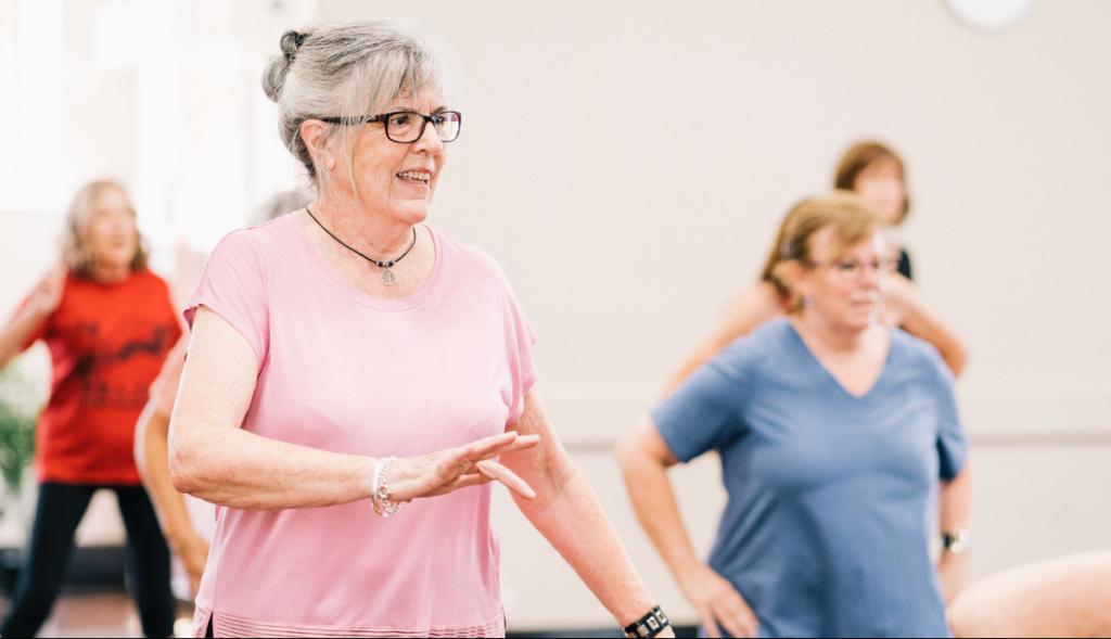 A group of older adults participate in a fitness class.